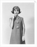 Smiling stylish young woman wearing sack dress gloves by Anonymous