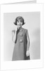 Smiling stylish young woman wearing sack dress gloves by Anonymous
