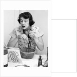 Woman face covered flour mixing ingredients reading brides cook book by Anonymous