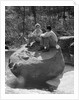 Couple man woman sitting on large rock in stream hugging knees smiling happy romance by Anonymous