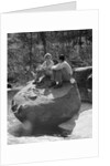 Couple man woman sitting on large rock in stream hugging knees smiling happy romance by Anonymous