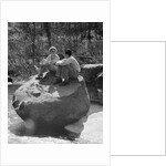 Couple man woman sitting on large rock in stream hugging knees smiling happy romance by Anonymous