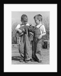 Boys in striped overalls holding piglet by Anonymous