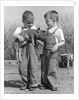 Boys in striped overalls holding piglet by Anonymous