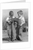 Boys in striped overalls holding piglet by Anonymous