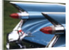 Detail fins rear tail lights blue cadillac auomobile by Anonymous