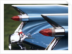 Detail fins rear tail lights blue cadillac auomobile by Anonymous