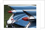 Detail fins rear tail lights blue cadillac auomobile by Anonymous