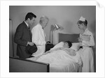 Doctor nurse husband talking with female patient in hospital bed by Anonymous