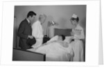 Doctor nurse husband talking with female patient in hospital bed by Anonymous