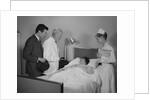 Doctor nurse husband talking with female patient in hospital bed by Anonymous