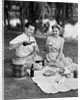 Man woman couple having a summer picnic outdoors drinking beer by Anonymous