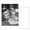 Man woman couple having a summer picnic outdoors drinking beer by Anonymous