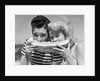 Teen age boy & girl eating slice watermelon by Anonymous