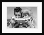 Teen age boy & girl eating slice watermelon by Anonymous