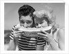 Teen age boy & girl eating slice watermelon by Anonymous