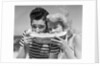 Teen age boy & girl eating slice watermelon by Anonymous