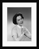 Brunette woman smiling happy satisfied proudly clasping hands to chest by Anonymous