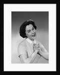 Brunette woman smiling happy satisfied proudly clasping hands to chest by Anonymous