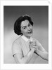 Brunette woman smiling happy satisfied proudly clasping hands to chest by Anonymous