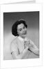 Brunette woman smiling happy satisfied proudly clasping hands to chest by Anonymous