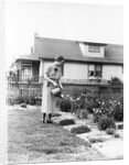 Woman watering garden with water can by Anonymous