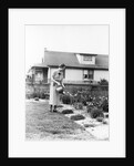 Woman watering garden with water can by Anonymous