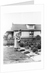 Woman watering garden with water can by Anonymous