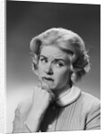 Blonde woman fist to chin worried serious facial expression by Anonymous