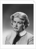 Blonde woman fist to chin worried serious facial expression by Anonymous