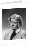Blonde woman fist to chin worried serious facial expression by Anonymous