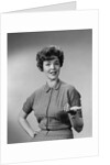 Brunette woman knit dress offhand gesture serious expression by Anonymous