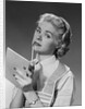 Blond woman wearing apron writing pad in hand pencil to chin thinking by Anonymous