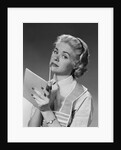 Blond woman wearing apron writing pad in hand pencil to chin thinking by Anonymous