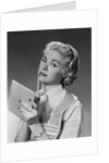 Blond woman wearing apron writing pad in hand pencil to chin thinking by Anonymous