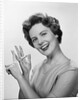 Smiling woman counting on fingers wearing pearls by Anonymous