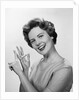 Smiling woman counting on fingers wearing pearls by Anonymous