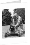 Elderly man in yard kneeling down to fix lawnmower by Anonymous