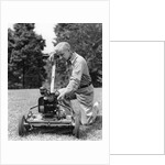 Elderly man in yard kneeling down to fix lawnmower by Anonymous