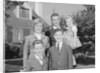 Family portrait father mother two sons and daughter in front of suburban house by Anonymous