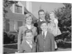 Family portrait father mother two sons and daughter in front of suburban house by Anonymous