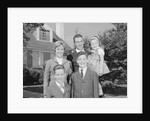 Family portrait father mother two sons and daughter in front of suburban house by Anonymous