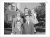 Family portrait father mother two sons and daughter in front of suburban house by Anonymous