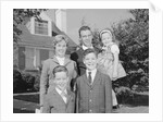 Family portrait father mother two sons and daughter in front of suburban house by Anonymous