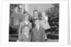 Family portrait father mother two sons and daughter in front of suburban house by Anonymous