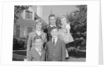 Family portrait father mother two sons and daughter in front of suburban house by Anonymous