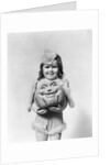 Happy smiling little girl in costume holding a papier-mache pumpkin head by Anonymous