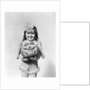 Happy smiling little girl in costume holding a papier-mache pumpkin head by Anonymous