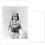 Happy smiling little girl in costume holding a papier-mache pumpkin head by Anonymous
