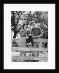 Smiling happy family mother father toddler boy portrait by farm fence by Anonymous
